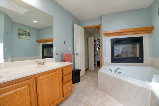 6020 Pebble Creek Dr, Fairview, PA 16415 - full bath featuring a glass covered fireplace, tile patterned flooring, a garden tub, double vanity, and a skylight