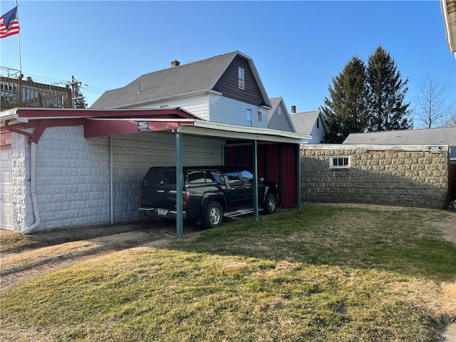 exterior space featuring a carport and a yard