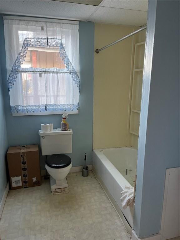 bathroom with toilet and bathing tub / shower combination