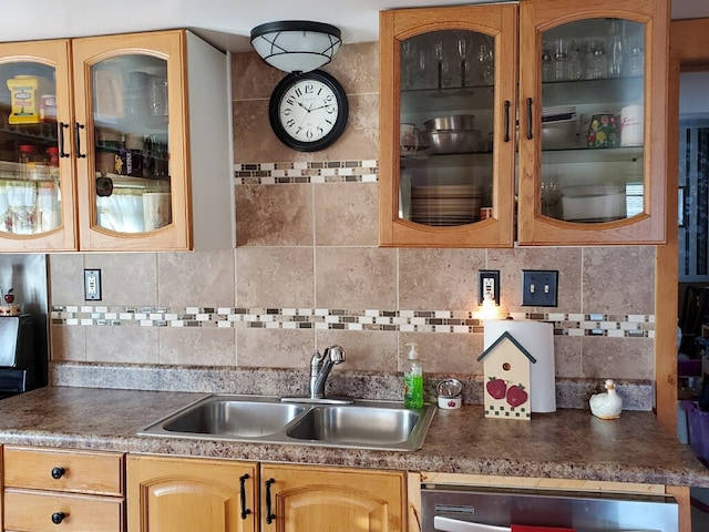 kitchen with decorative backsplash, sink, and stainless steel dishwasher