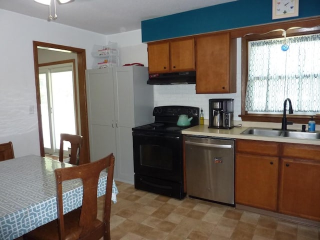 3404 Rustic Ln, Erie, PA 16506 - kitchen with dishwasher, under cabinet range hood, black range with electric cooktop, brown cabinets, and light countertops