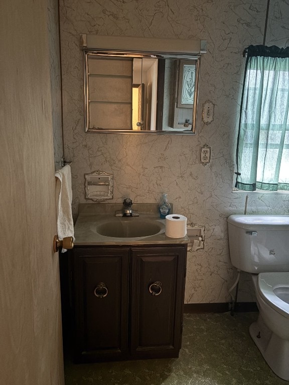 half bathroom with toilet and vanity