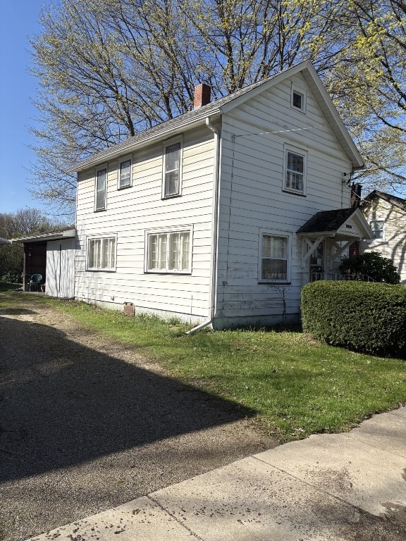 view of home's exterior featuring a chimney