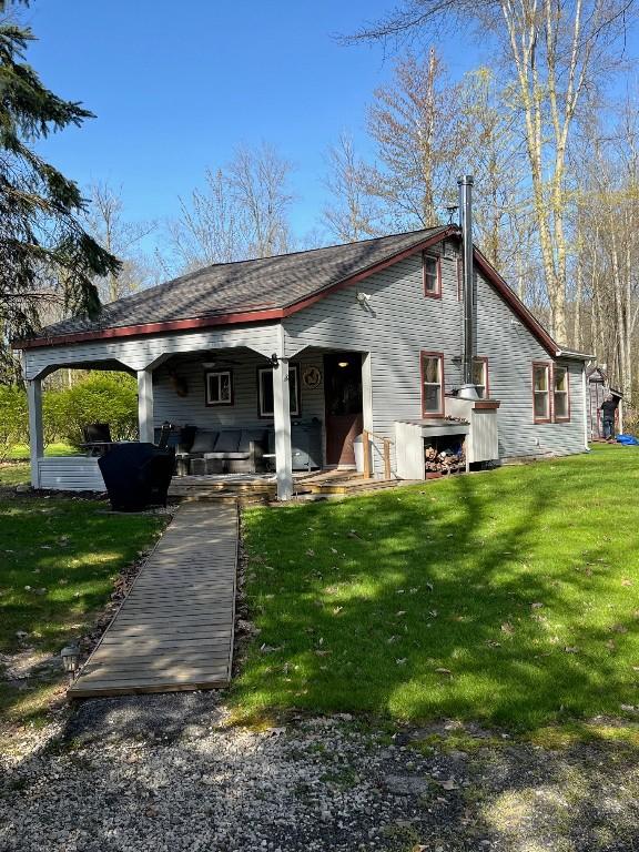 rear view of house with a lawn