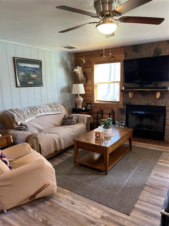 8766 Quaker Ln, Espyville, PA 16424 - living room featuring ceiling fan, wood finished floors, and a fireplace