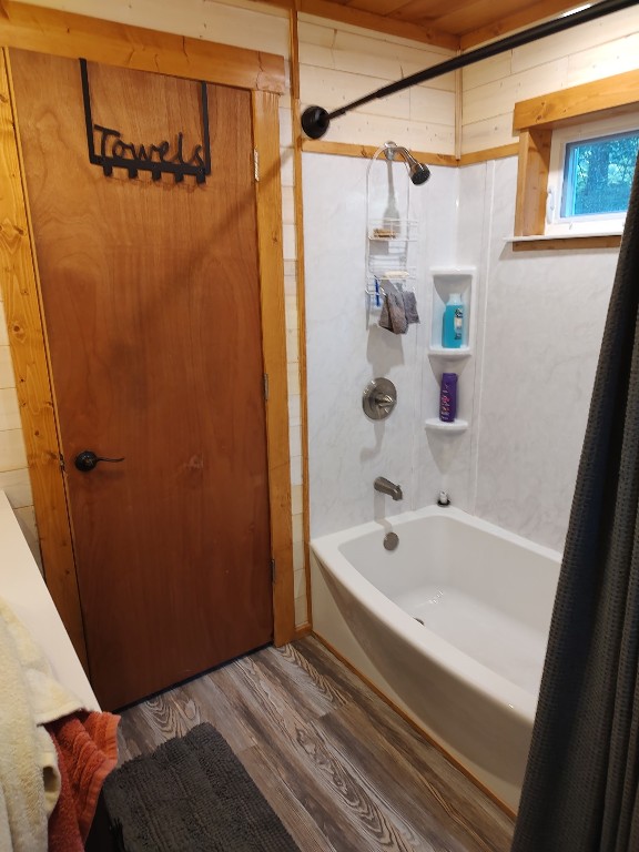 8766 Quaker Ln, Espyville, PA 16424 - full bath featuring shower / bath combo with shower curtain and wood finished floors