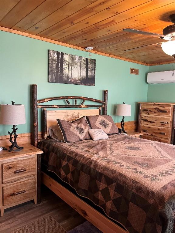 bedroom with wooden ceiling, a ceiling fan, an AC wall unit, and wood finished floors