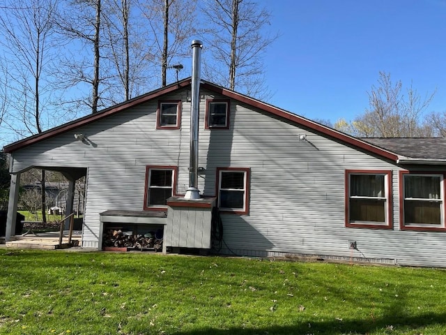back of property with a lawn