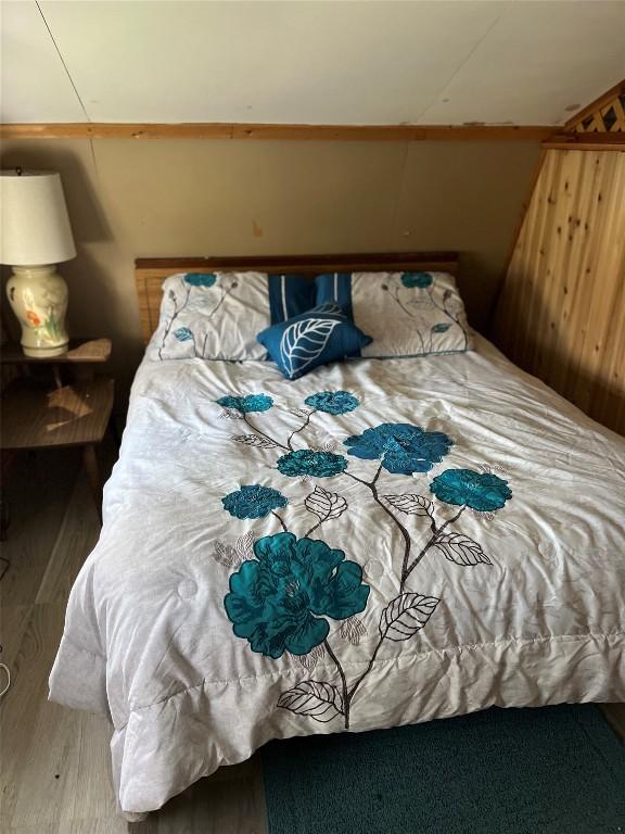 bedroom with wood walls
