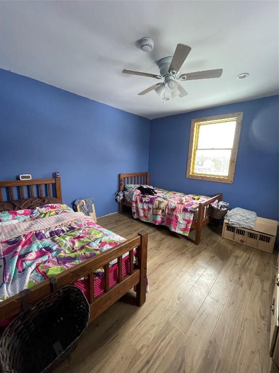 bedroom featuring ceiling fan and wood finished floors