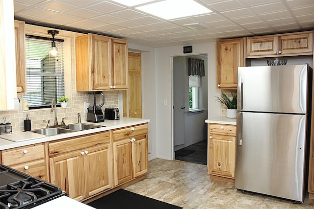 6361 Cherry Ext, Erie, PA 16509 - kitchen featuring freestanding refrigerator, plenty of natural light, and tasteful backsplash