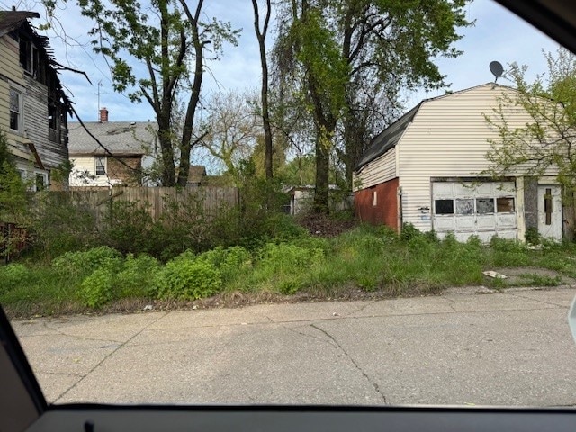 1201 E 21st St, Erie, PA 16503 - view of side of home with fence, a gambrel roof, and an outbuilding