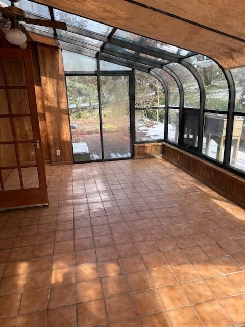 unfurnished sunroom with a ceiling fan