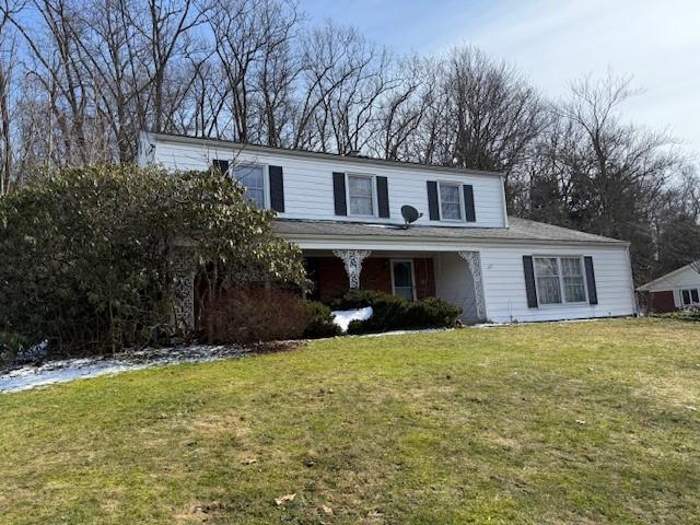 traditional-style home with a front lawn