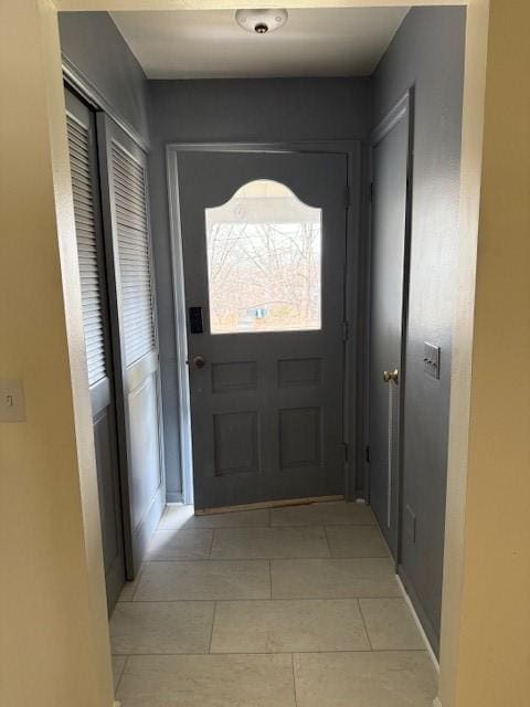 doorway to outside featuring light tile patterned floors