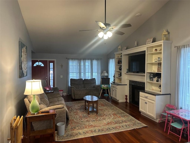 living room with dark wood-style floors, a ceiling fan, vaulted ceiling, and a premium fireplace