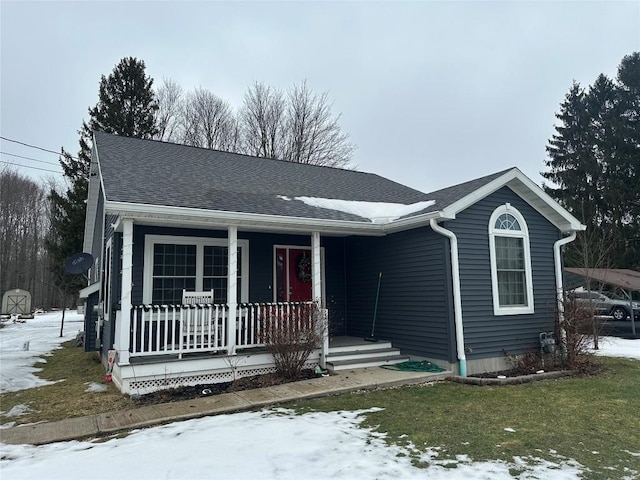 view of front of home featuring a porch and a shingled roof