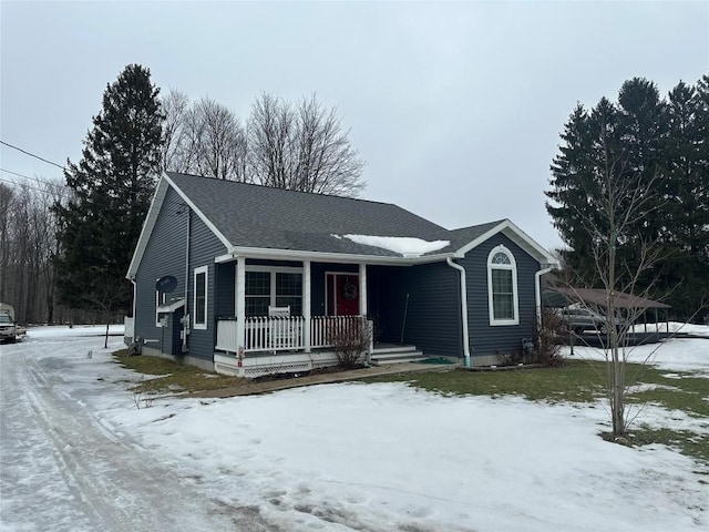 ranch-style house featuring covered porch and a shingled roof