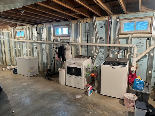 basement with refrigerator and washing machine and clothes dryer