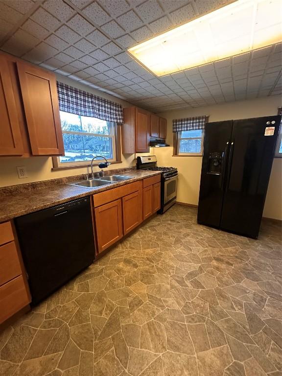 kitchen with a wealth of natural light, sink, and black appliances