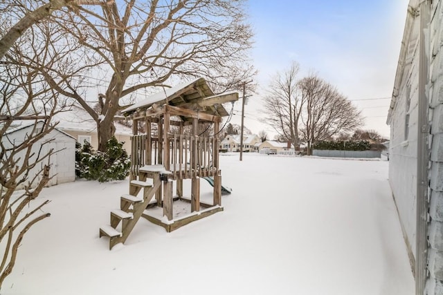 snowy yard with a playground