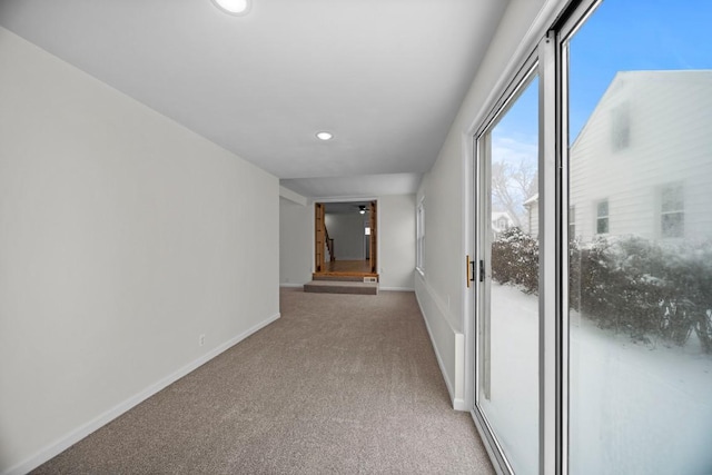 corridor featuring light colored carpet