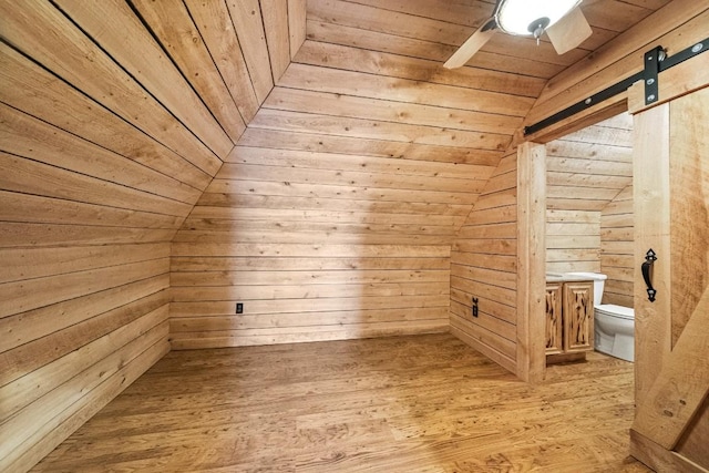 100 Fox Hollow Ln, Harborcreek, PA 16511 - additional living space featuring wood ceiling, wood walls, a barn door, light wood-style floors, and ceiling fan