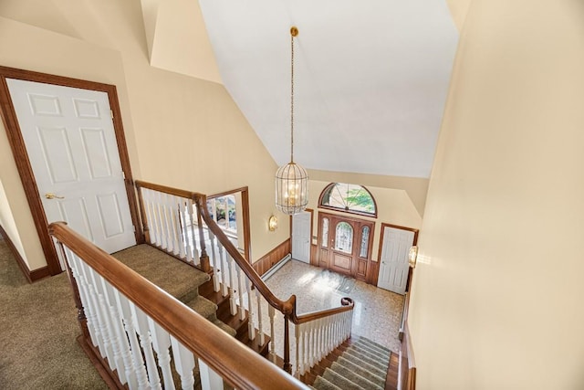 100 Fox Hollow Ln, Harborcreek, PA 16511 - carpeted entryway featuring high vaulted ceiling, a chandelier, baseboards, and stairway
