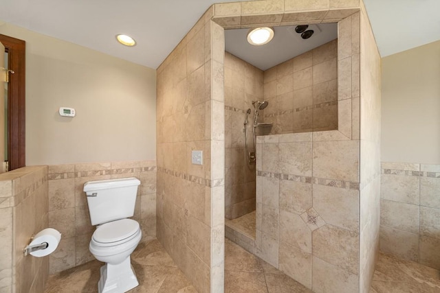 100 Fox Hollow Ln, Harborcreek, PA 16511 - full bathroom featuring tile walls, toilet, walk in shower, wainscoting, and tile patterned floors