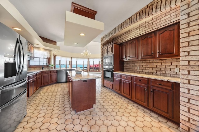 100 Fox Hollow Ln, Harborcreek, PA 16511 - kitchen with stainless steel appliances, a center island, a chandelier, light stone counters, and recessed lighting