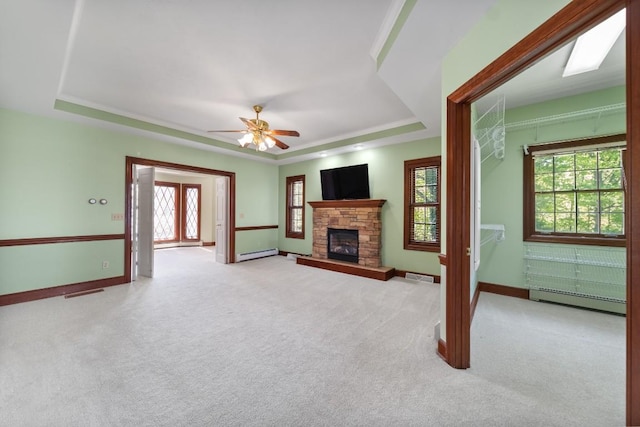 100 Fox Hollow Ln, Harborcreek, PA 16511 - unfurnished living room with a baseboard heating unit, a raised ceiling, a ceiling fan, and a fireplace