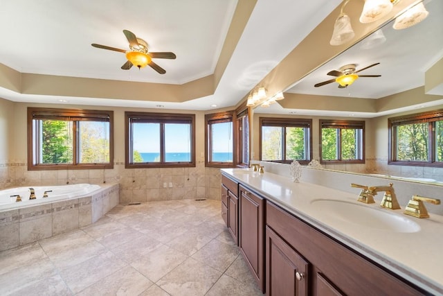 100 Fox Hollow Ln, Harborcreek, PA 16511 - bathroom featuring ceiling fan, a raised ceiling, healthy amount of natural light, tile walls, and crown molding