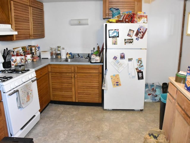 kitchen with a sink, white appliances, extractor fan, and light countertops