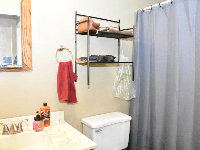 bathroom featuring vanity, a shower with shower curtain, and toilet