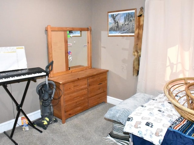 carpeted bedroom featuring baseboards