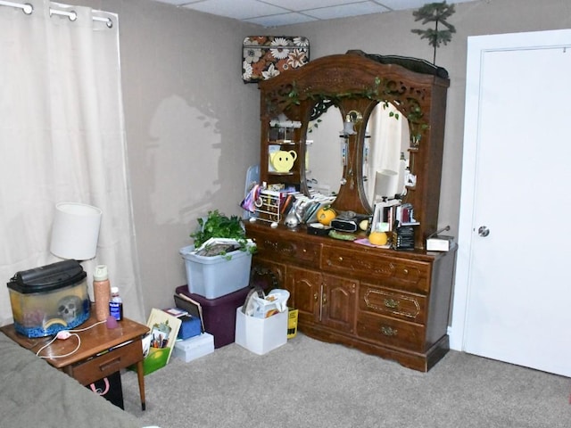 carpeted bedroom with a drop ceiling