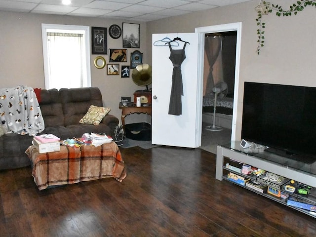 living room featuring wood finished floors and a paneled ceiling