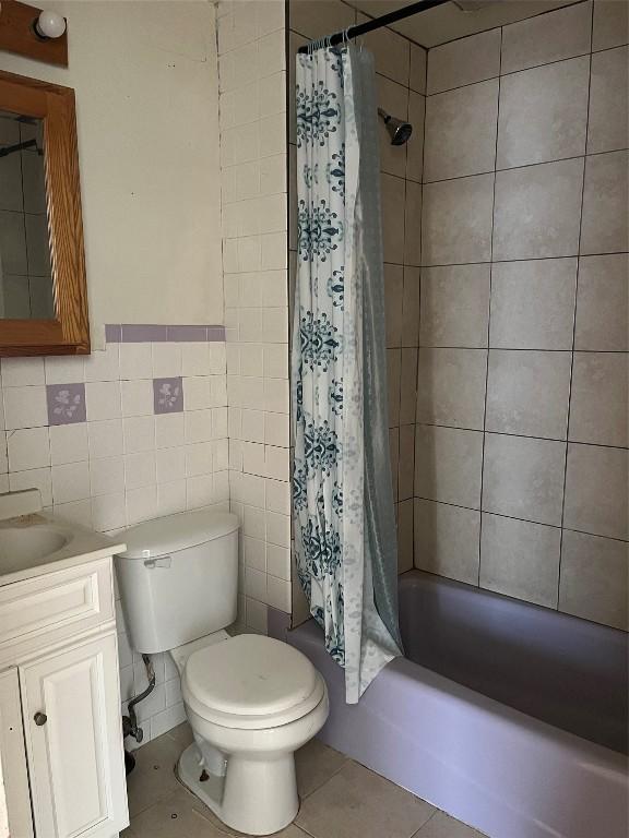 2627 Van Buren Ave, Erie, PA 16504 - full bath with tile walls, vanity, toilet, shower / bath combination with curtain, and tile patterned flooring