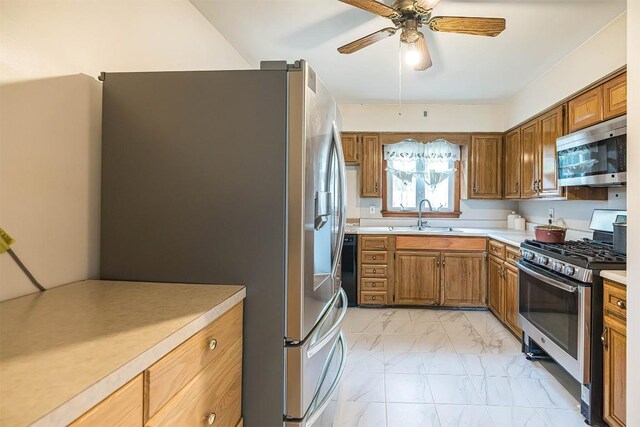 1303 Anna Ct, Erie, PA 16504 - kitchen featuring appliances with stainless steel finishes, a sink, light countertops, a ceiling fan, and brown cabinetry