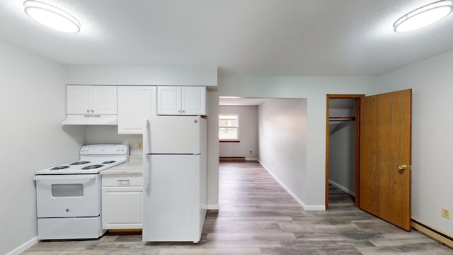 kitchen featuring white cabinetry, light hardwood / wood-style flooring, a textured ceiling, a baseboard radiator, and white appliances