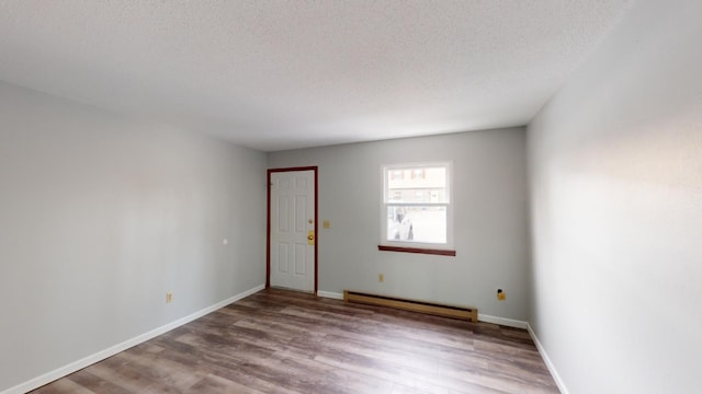 unfurnished room with a baseboard radiator, light hardwood / wood-style floors, and a textured ceiling