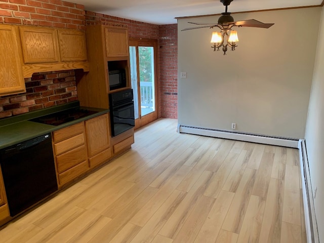 kitchen with brick wall, ceiling fan, a baseboard heating unit, black appliances, and light hardwood / wood-style floors