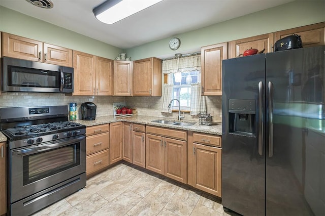 2514 E 43rd St, Erie, PA 16510 - kitchen featuring appliances with stainless steel finishes, a sink, backsplash, and light stone countertops