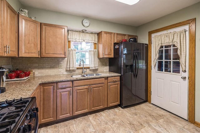 2514 E 43rd St, Erie, PA 16510 - kitchen with black fridge, a sink, backsplash, and brown cabinetry