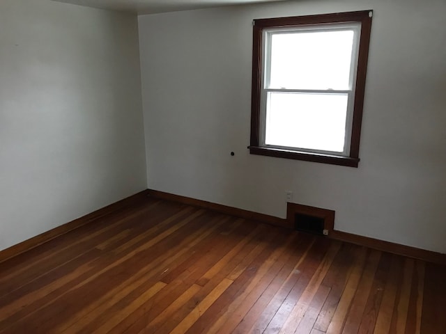 unfurnished room with dark hardwood / wood-style floors