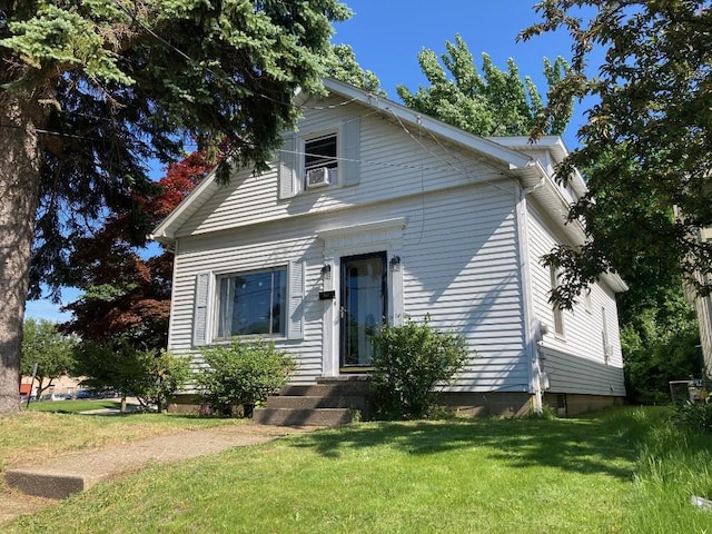 bungalow-style house with a front lawn