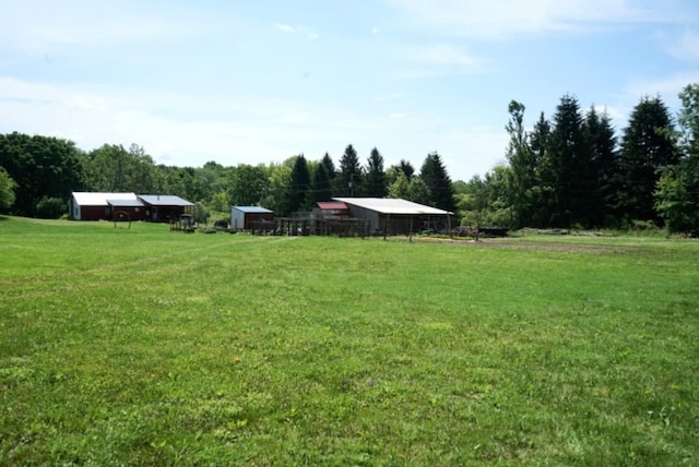 17315 Phelps Rd, Linesville, PA 16424 - view of green lawn with an outbuilding, a rural view, a wooded view, and a pole building
