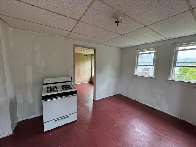 kitchen with white range with gas stovetop and a paneled ceiling