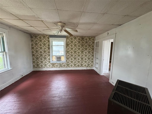 unfurnished room featuring built in shelves, ceiling fan, and cooling unit