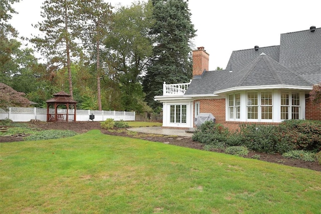 view of yard with a gazebo and french doors